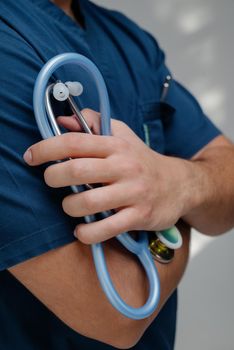 Blue medical stethoscope.A doctor with a stethoscope.A doctor holding a stethoscope.The concept of healthcare.