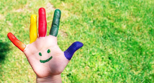 Children's hands in the colors of summer. Selective focus.nature