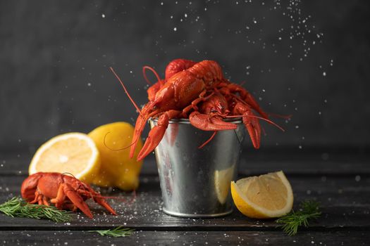 Boiled cooked crayfish ready to eat on black background