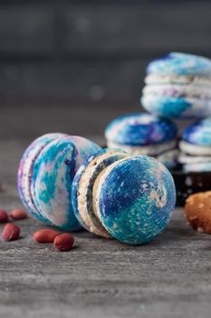 Blue macaroons on a grey concrete background. Vertical