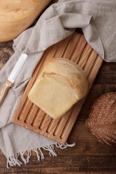 Natural bread loaf on wooden background