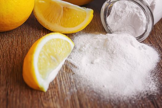 Citric acid on a wooden background with lemon. Selective focus.food