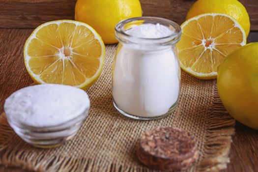 Citric acid on a wooden background with lemon. Selective focus.food