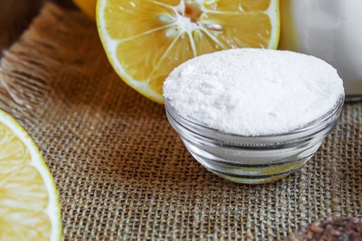 Citric acid on a wooden background with lemon. Selective focus.food