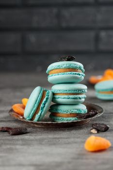 Blue macaroons on a grey concrete background. Vertical