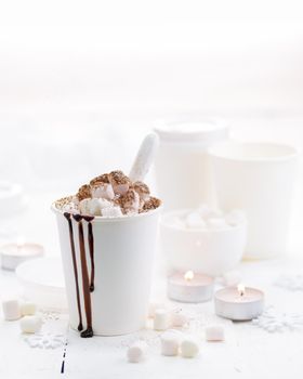 Hot cocoa with marshmallow in a white mug on a white background