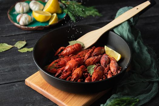 Boiled cooked crayfish ready to eat on black background