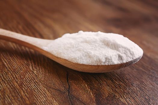 Citric acid on a wooden background with lemon. Selective focus.food