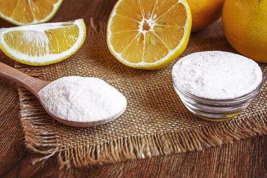 Citric acid on a wooden background with lemon. Selective focus.food