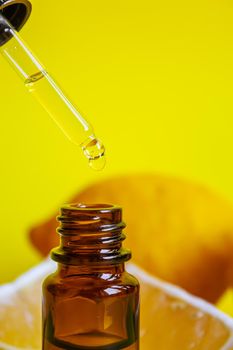 lemon essential oil on a yellow background. Selective focus.nature