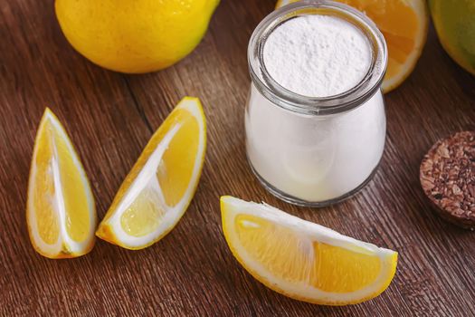 Citric acid on a wooden background with lemon. Selective focus.food