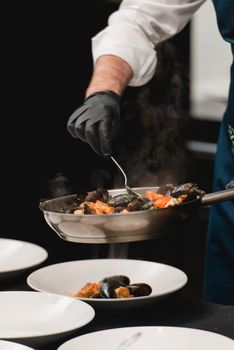 the chef prepares a seafood dish