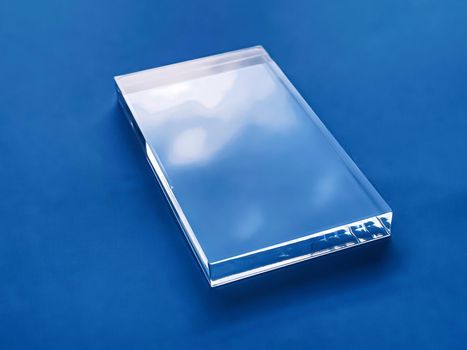 Transparent glass device on blue background, future technology and abstract screen mockup design concept