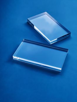 Transparent glass device on blue background, future technology and abstract screen mockup design concept