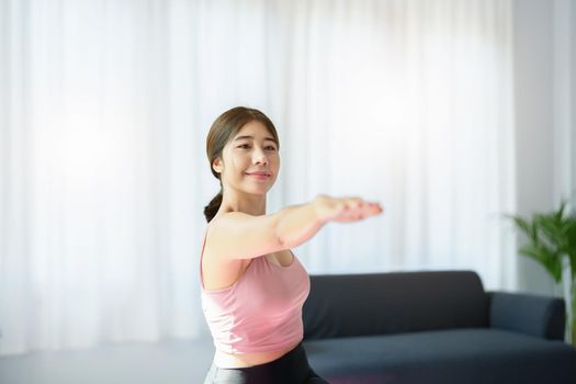 stress relief, muscle relaxation, breathing exercises, exercise, meditation, portrait of Young Asian woman relaxing her body from office work by practicing yoga by watching online tutorials