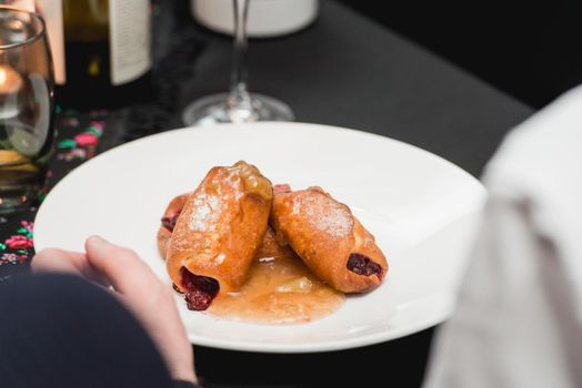 flying buns with fruits on a white plate.