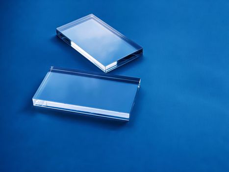 Transparent glass device on blue background, future technology and abstract screen mockup design concept