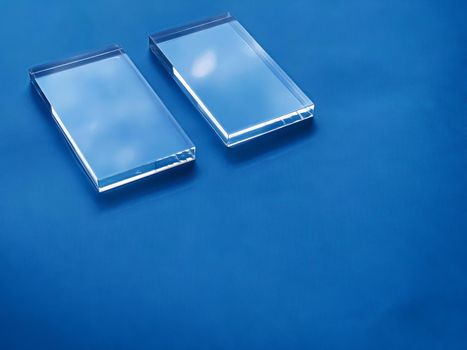 Transparent glass device on blue background, future technology and abstract screen mockup design concept