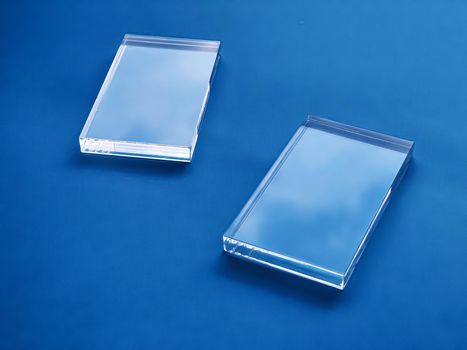 Transparent glass device on blue background, future technology and abstract screen mockup design concept