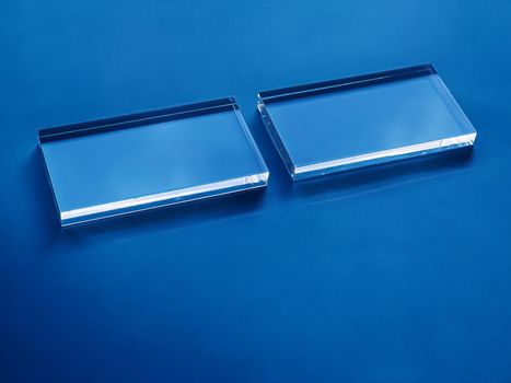 Transparent glass device on blue background, future technology and abstract screen mockup design concept