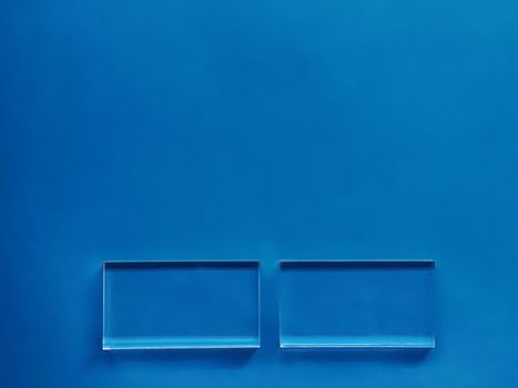 Transparent glass device on blue background, future technology and abstract screen mockup design concept