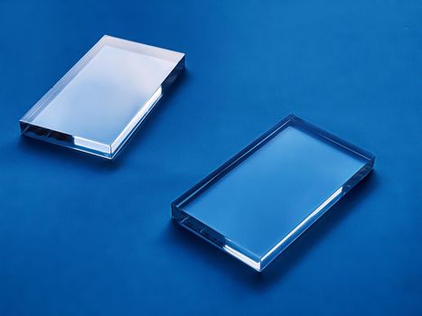 Transparent glass device on blue background, future technology and abstract screen mockup design concept