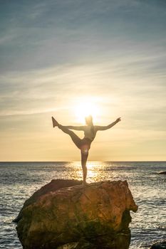 Girl gymnast is training on the beach by the sea sunset. Does twine. Photo series