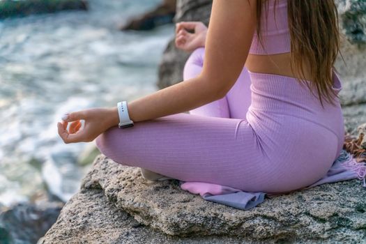 Young woman practicing yoga outdoors. Harmony and meditation concept. Healthy lifestyle.