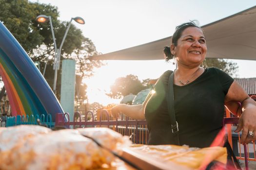 Itinerant fruit vendor in a park in Managua Nicaragua smiling at sunset. Concept of self-employment in Latin America.