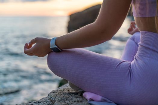 Young woman practicing yoga outdoors. Harmony and meditation concept. Healthy lifestyle.