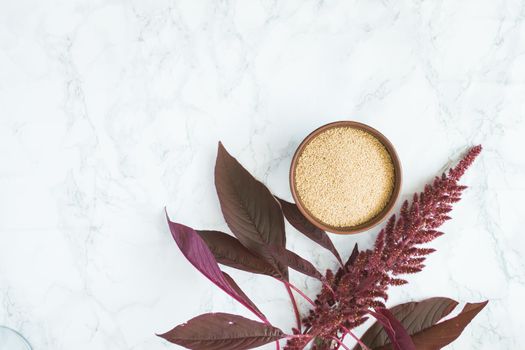 amaranth grain with oil on a white background with space for text. High quality photo