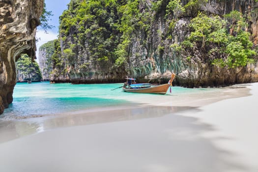 The Thai traditional wooden longtail boat and beautiful beach in Phuket province, Thailand.