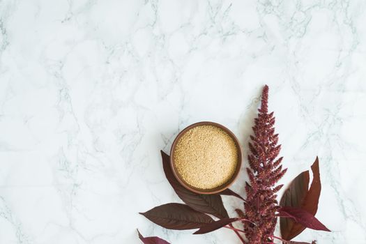 amaranth grain with oil on a white background with space for text. High quality photo