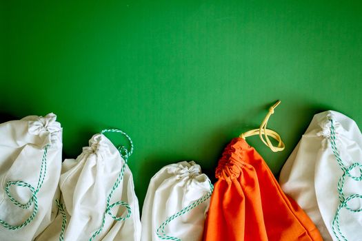 zero waste products in reusable cotton bags on a green background. High quality photo