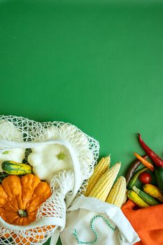 zero waste products in reusable cotton bags on a green background. High quality photo