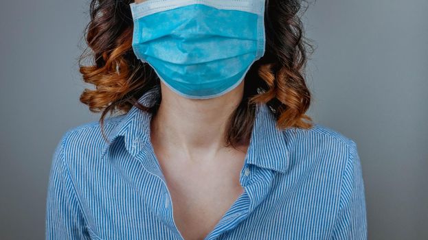 Woman wearing protection face mask against coronavirus. Medical mask, Surgical mask, Close up shot, Select focus, Prevention from covid19