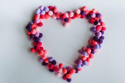 A beautiful big heart made of soft pom-poms against a light background. Heart love, love background, place for text