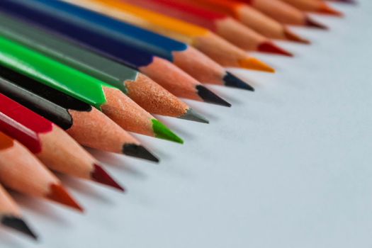 Row of multicolored wooden pencil collection isolated on white background