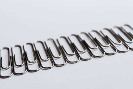 Metal paper clips on white