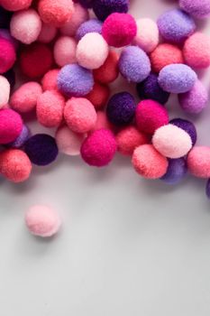 close up colorful pom poms texture background, heap of small pastel color fluffy ball for crafts and fashion accessories decoration, selective focus