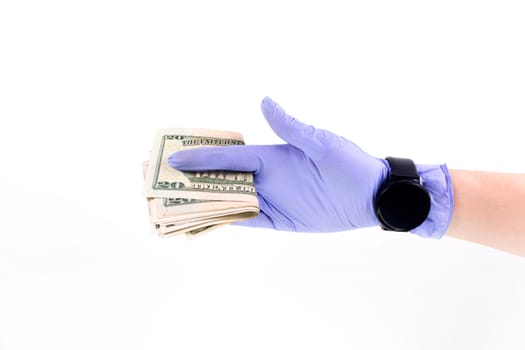 World money concept, hand with gloves receiving, giving or holding 20 USD banknote, isolated on blurred background. Corona virus COVID-19 outbreak. Concept of prevention virus spread