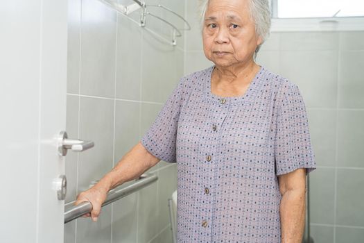 Asian senior or elderly old lady woman patient use toilet bathroom handle security in nursing hospital ward, healthy strong medical concept.