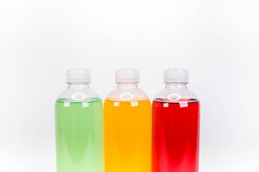 Energy drinks bottles with different flavors on a white background. Juice bottles