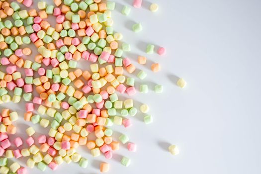 Colorful marshmallows white background with copy space. Top view