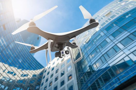 Drone with digital camera flying in a modern city: 3D rendering