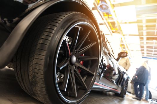 Back of a generic black sport car in sunlight