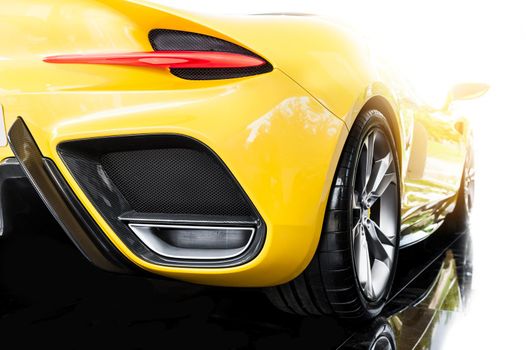 Back of a yellow modern sport car in sunset