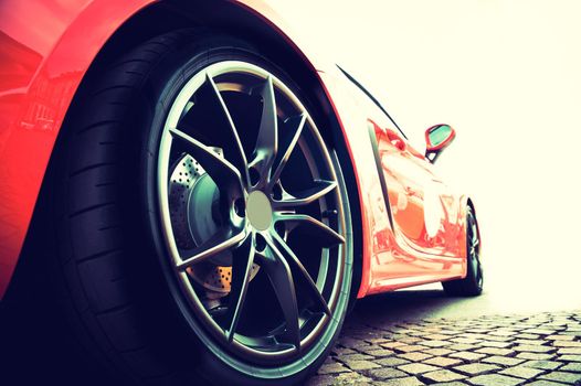 Back of a red modern sport car in sunset