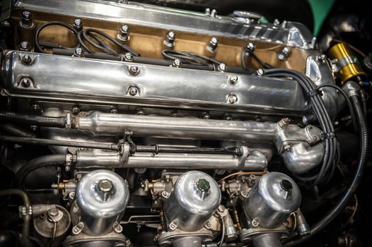 Close up of a vintage chrome car engine
