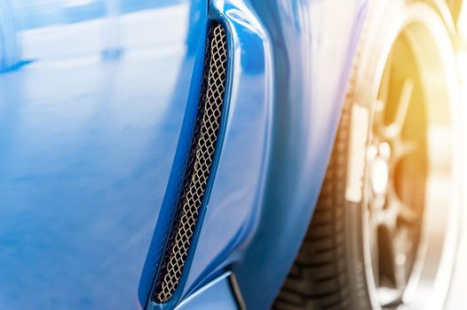 Close up on a blue car in sunlight